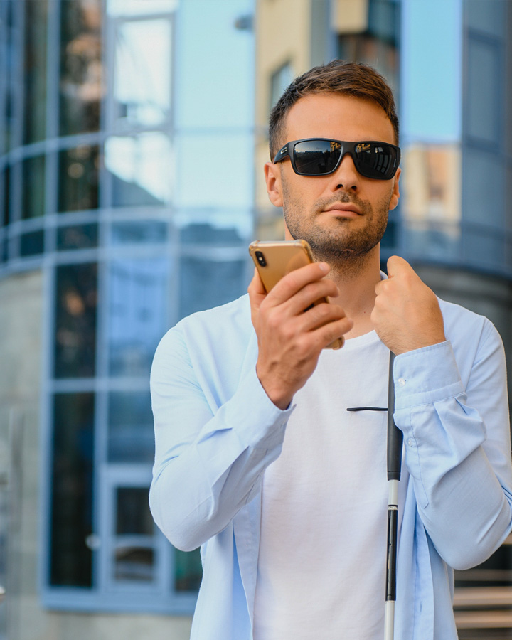 Vision impaired man using assistive technology on his mobile phone for directions