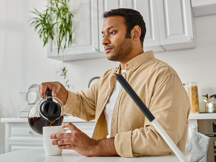 Vision impaired man preparing coffee in his kitchen